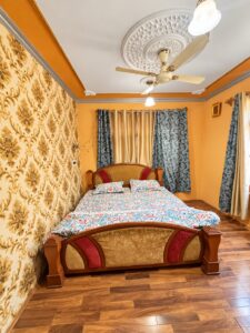 Doctors Lodge Srinagar floral double bedroom — enhanced original photo