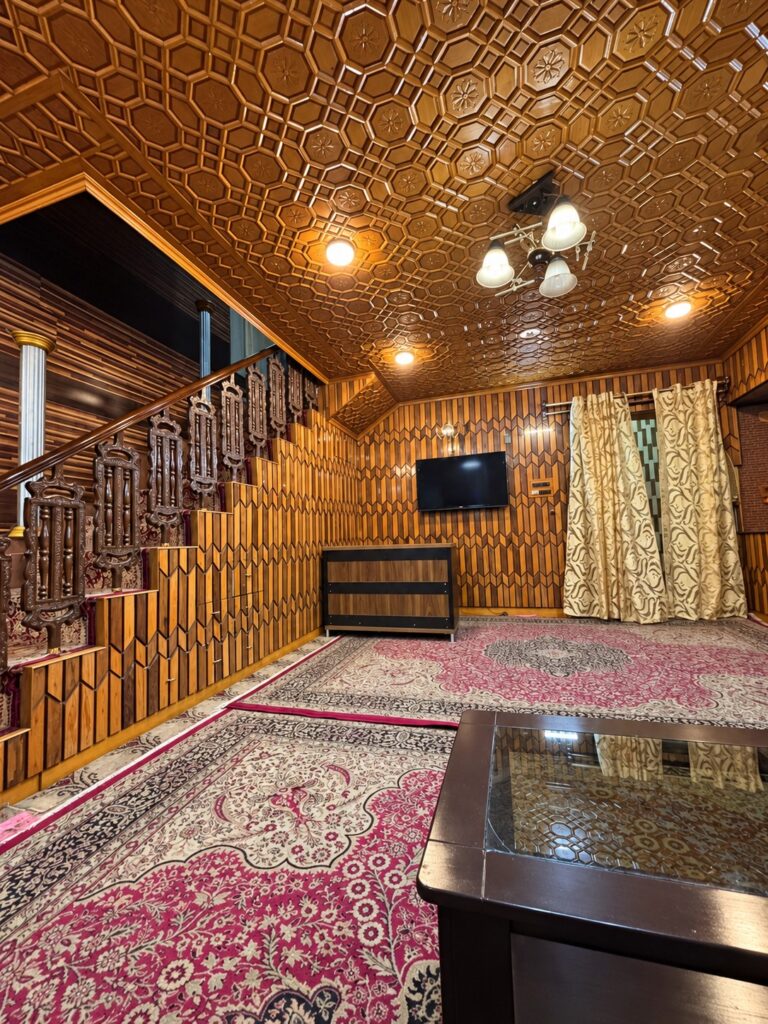 Doctors Lodge Srinagar wood-panelled lounge — enhanced original photo